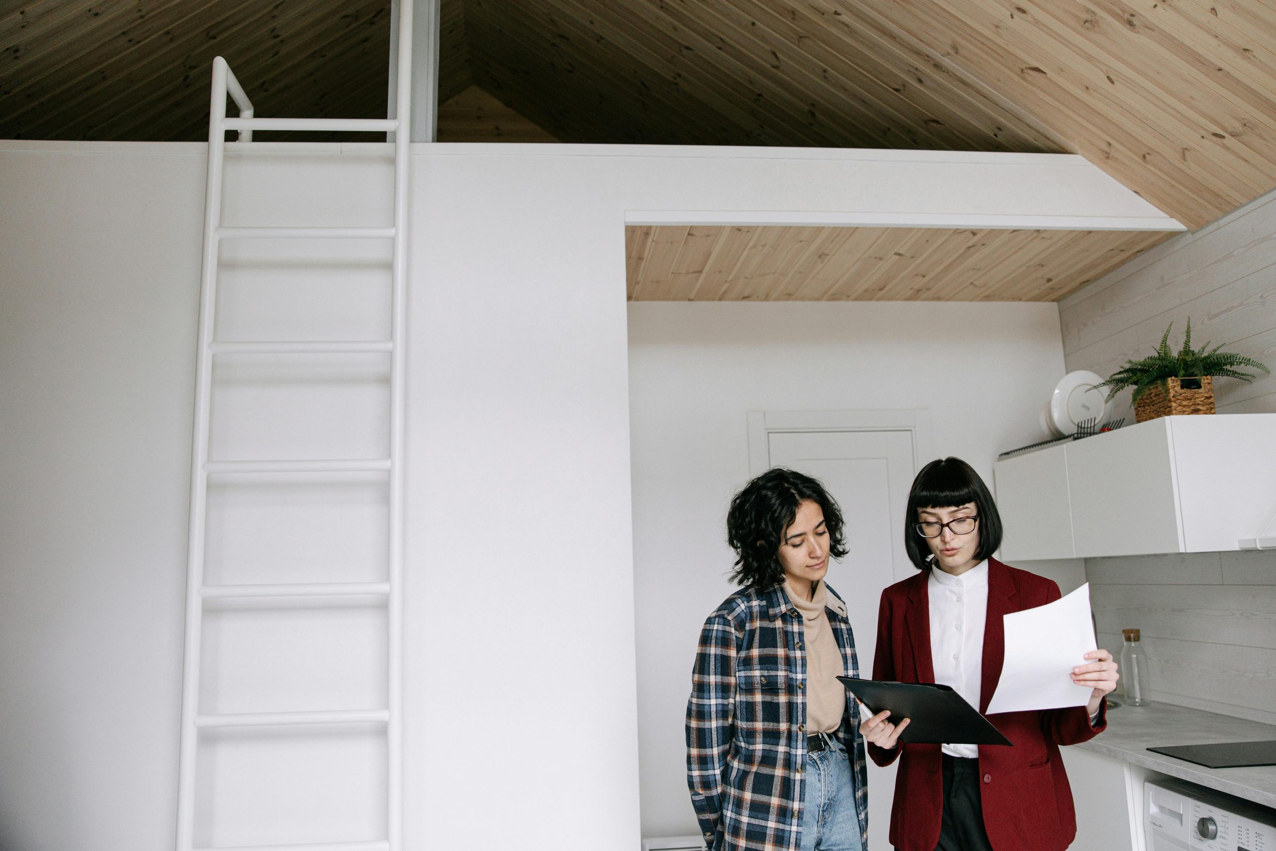 landlord holding papers while talking to a tenant